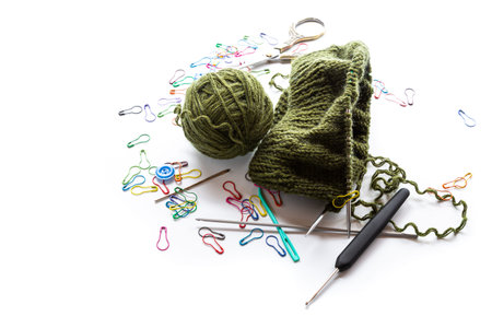 handmade knitting project with wool yarn and knitting tools.