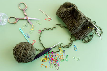 knitting tools and yarn flat lay craft hobby background.