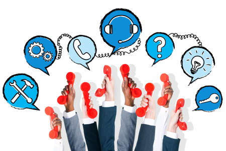 Multi-ethnic hands holding red phone and speech bubbles with communication concepts  