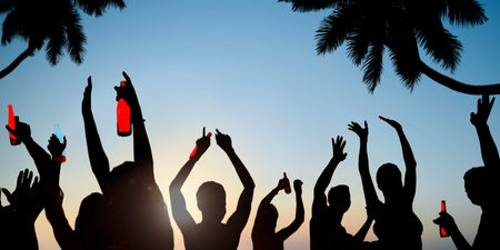 Silhouettes of Young People Celebrating, Drinking on a Beach