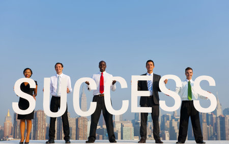 A group of office workers holding SUCCESS letters.