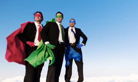 Business superhero posing unanimaously and looking away from the camera.