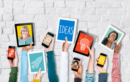 Group of Hands Holding Digital Devices with Ideas Concept