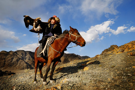 Kazakh men traditionally hunt foxes and wolves using trained golden eagles. Olgei,Western Mongolia.