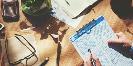 Businessman Filling Up Form on Office Desk Concept
