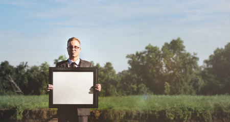 Businessman Holding Picture Frame Copy Space Concept