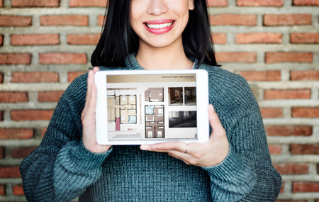 Asian Lady Showing Floor Plan on Tablet Concept