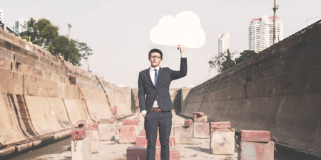 Businessman Holding Cloud Network Symbol Concept