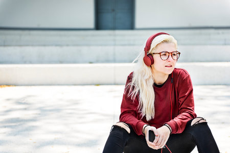 Young Woman Skater Browsing Phone Concept