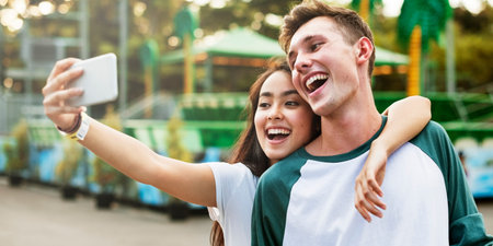 Teenage Couple Amusement Park Selfie Concept