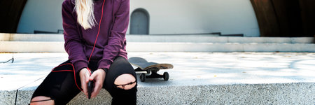 Young Woman Skater Listening Music Concept