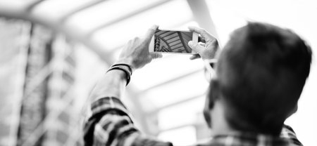 Young Man Taking Photo Smartphone Concept