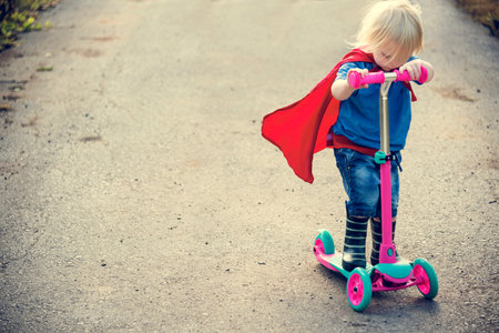 Superhero Baby Boy Using Scooter Adorable Concept