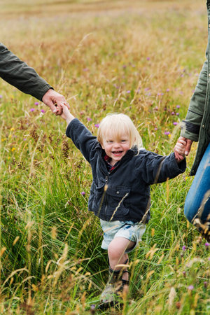 Family Parents Holding Hands Boy Swinging Concept