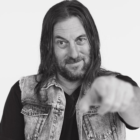Adult Male Biker Pointing Smiling Concept