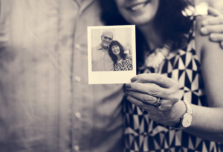 Close up couple showing instant camera image