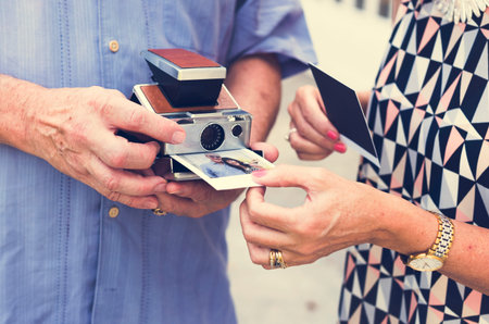 Couple printing a photo on instant camera