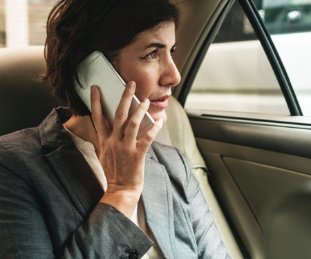 Businesswoman Talking Using Phone Car Inside