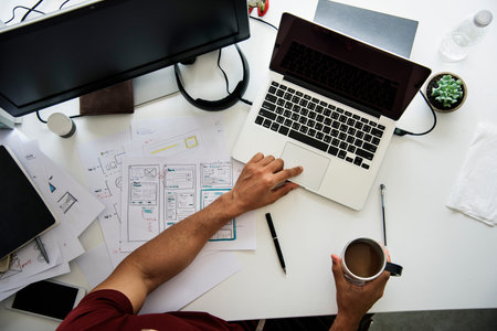 A Man Working Plan On A White Table