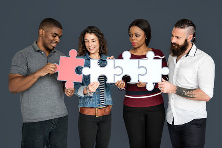 People are holding puzzle together