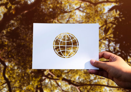 Hand Hold Globe Paper Carving with Nature Background