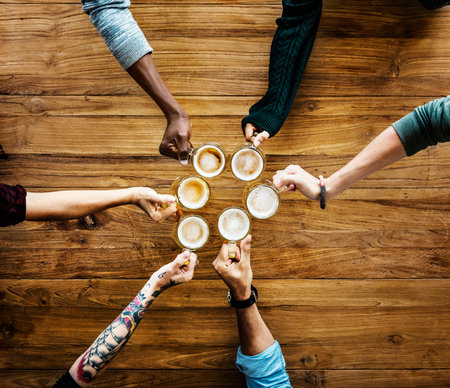 Group of people hand assemble together with coffee in aerial view
