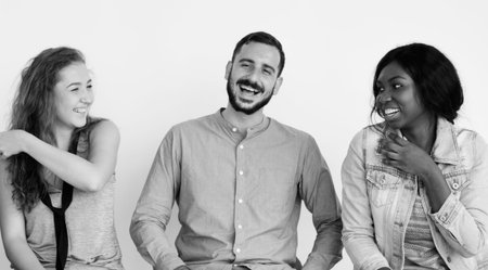 Group of cheerful people sitting in a row
