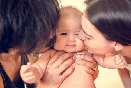 Father and mother are taking care of their child.