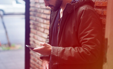 Man using smart phone browsing outside