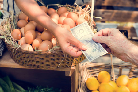 Greengrocer selling organic fresh agricultural product at farmer market