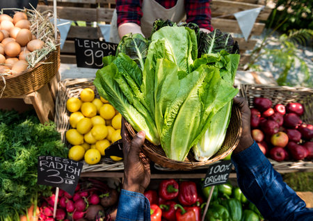 Greengrocer selling organic fresh agricultural product at farmer market