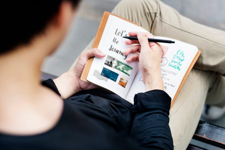 Young man writing diary travel book wanderlust