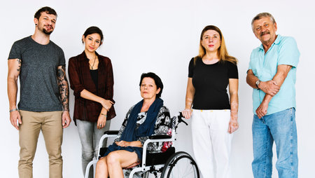 Group of people smiling with lady on wheelchair