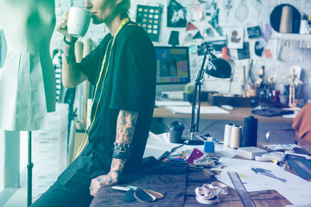 Fashion designer having a break with coffee
