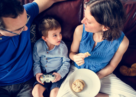 Family playing video game together on weekend holiday