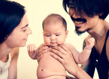 Father and mother are taking care of their child.