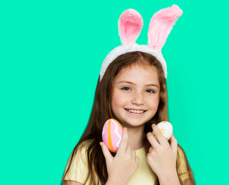 Children with bunny hairband and easter eggs