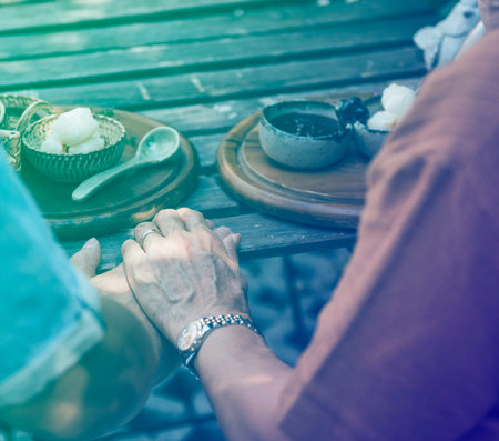 Couple holding hands and having sweet dessert