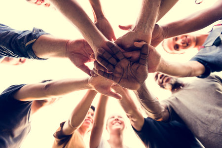 Diverse Group of People Hands Together Partnership Teamwork