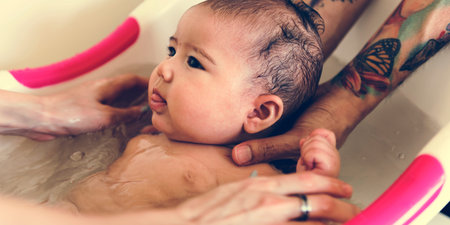 Father and mother are taking care of their child.