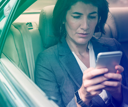 Businesswoman Talking Using Phone Car Inside