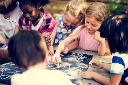 Group of children drawing on blackboard