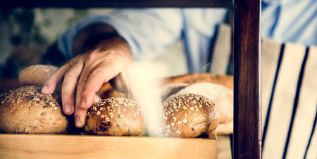 Man Hand Picking Baked Bread