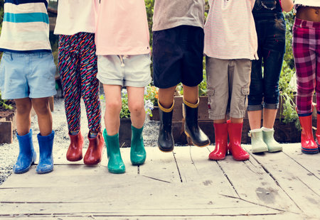 Group of kindergarten kids learning gardening outdoors