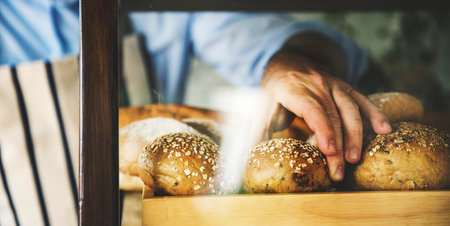 Man Hand Picking Baked Bread
