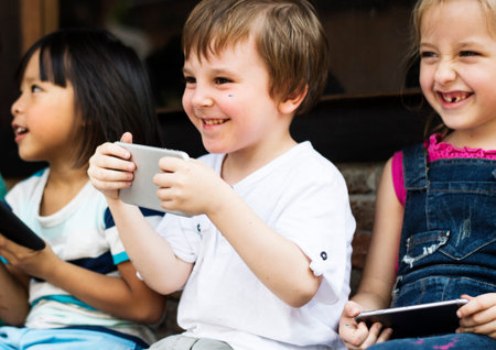 Group of Diverse Kids Using Mobile Phone Device Together