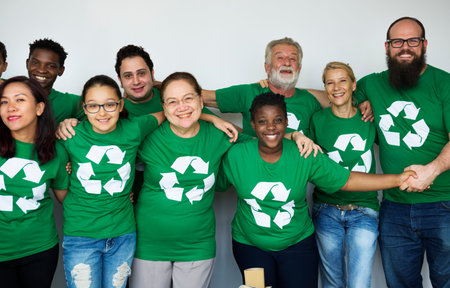 People in group wearing recycle icon shirts and posing for photoshoot