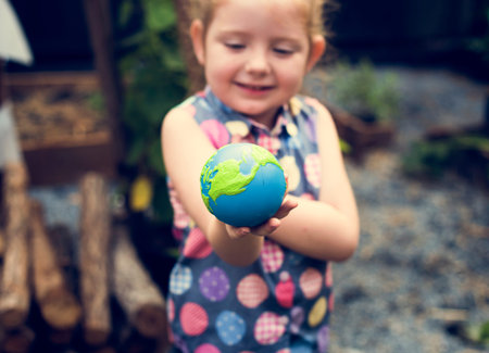 Little girl is holding a planet ball