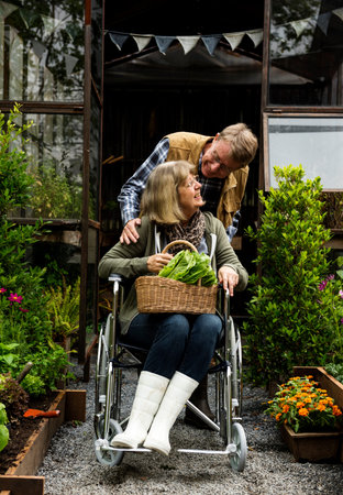 Senior couple planting vegetables at garden backyard