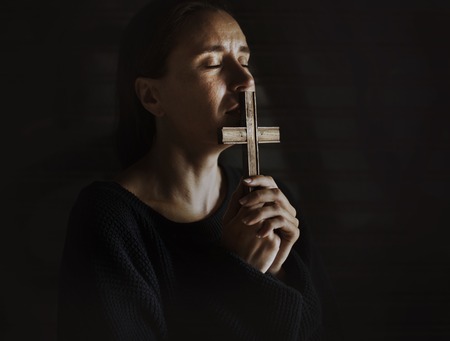 Foto de Adult Woman Hands Holding Cross Praying for God Religion - Imagen libre de derechos